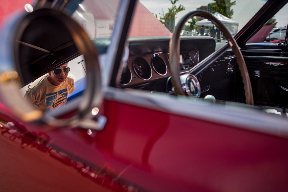 A visitor checks out the interior of a 1965 Pontiac GTO Convertible on display in the parking lot of Scarborough Town Centre during the second annual Show 'n Shine car show on Sunday.  Proceeds from the event went to support  the Rouge Valley Health System. (July 21, 2013)