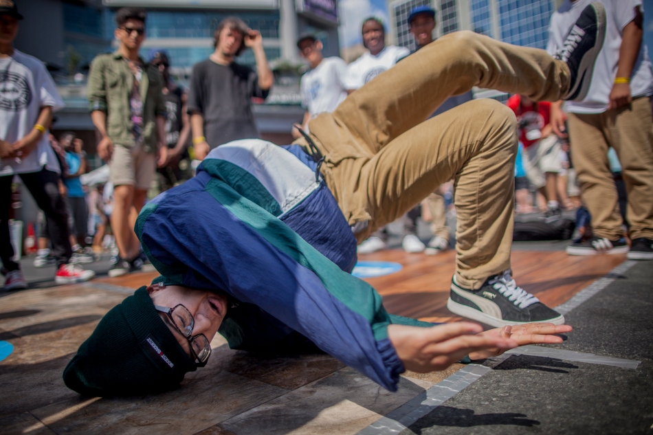 Tristan Mina, 16, break-dances on one of the side stages at Unity Festival in Younge and Dundas Square on Saturday.  Proceeds from the show went to support the Unity charity which provides leadership outreach to youth. (July 20, 2013)