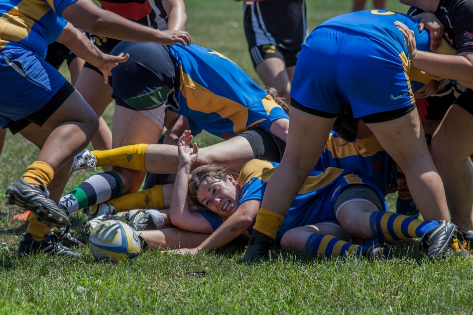 The Balmy Beach's Emily Calley protects herself after being tackled in a scrum during the teams only home game this season against the Oshawa Vikings at Tubs and Gee Gage field on Saturday.  Oshawa defeated the Beach's 24-17. (July 20, 2013)