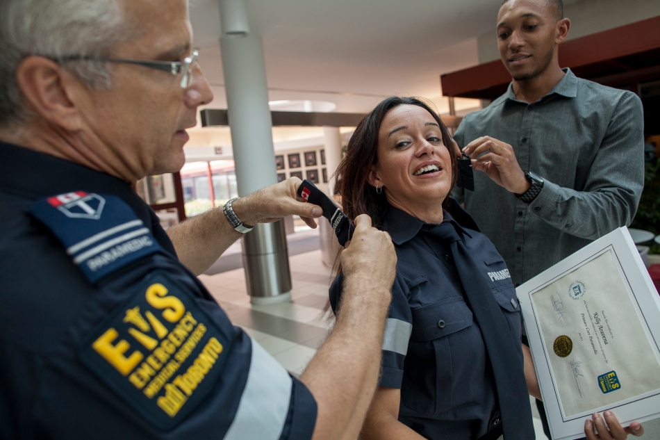 Kelly Aravena receives her epaulette becoming one of Toronto's newest paramedics on Friday at Toronto EMS Headquarters. The city welcomed 25 new paramedics to the EMS service. (July 19, 2013)
