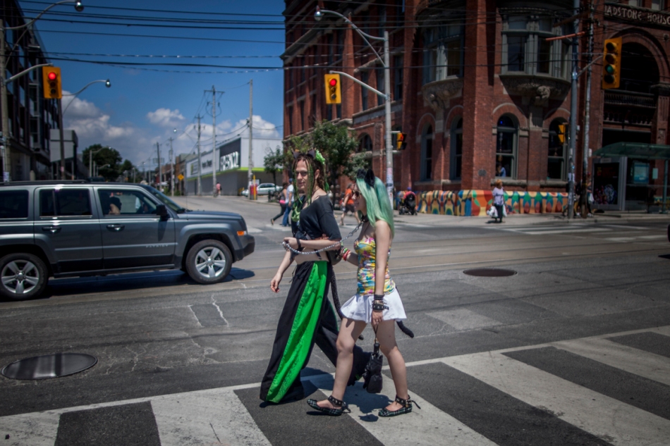 Kai'enne leads her sub, Ava, down Queen Street West on Sunday. (July 14, 2013)