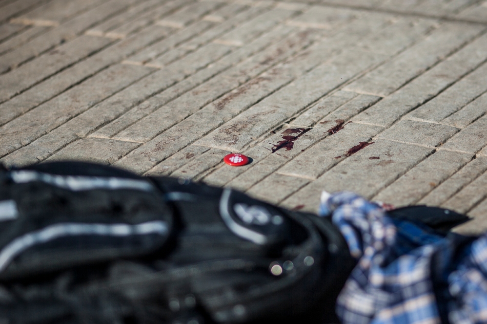 Blood, clothes and a pin belonging to one of the victims of a stabbing incident at Salsa on St. Clair, lay on the street on Sunday. (July 14, 2013)