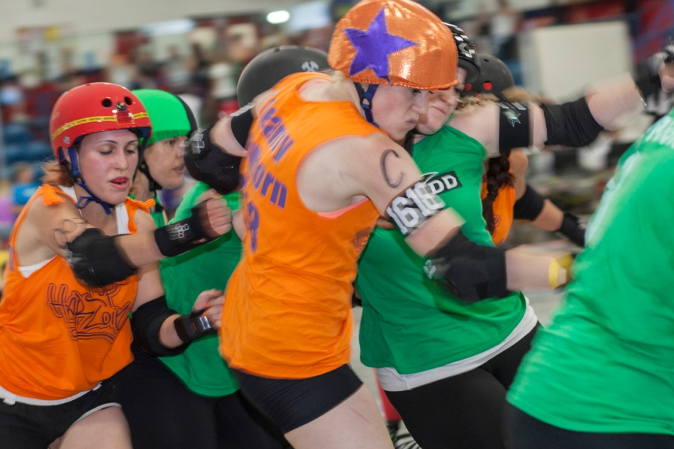 Top Herloins' 'Steamy Steelborn,' in orange, from Guelph takes a check from the Cannon Dolls' 'Punch Buggies,' from Ottawa, battle it out at the start of a bout during The Fresh and the Furious an all day roller derby hosted at Ted Reeve Arena on Saturday. (July 13, 2013)