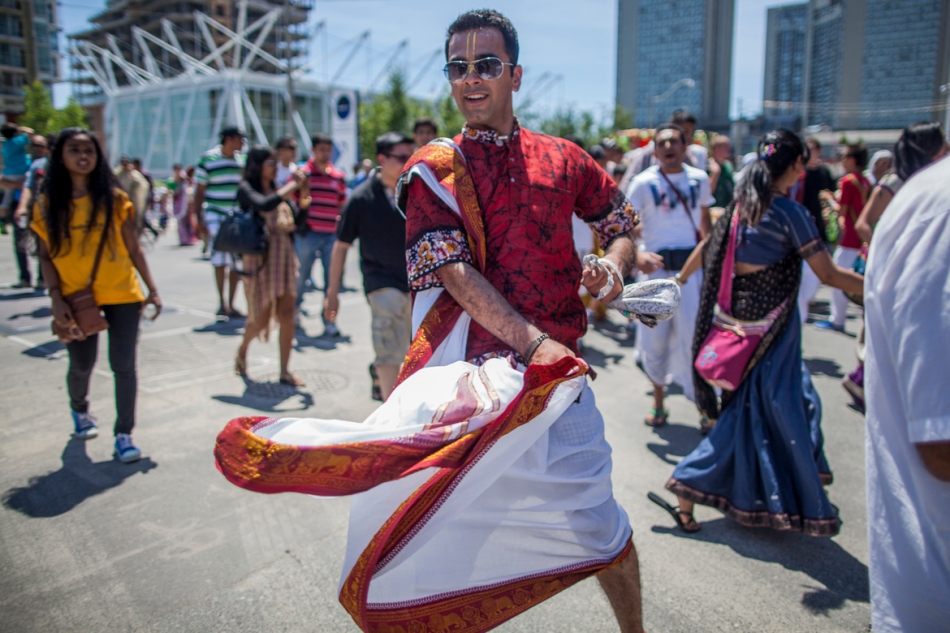 Surendre Gandhi, Originally from Bombay India f dances down Queens Quay as part of the Festival of India parade on Saturday.  The parade went down Younge Street from Bloor to the waterfront where the festival moved to Toronto Island for two days of festivities. (July 13, 2013)