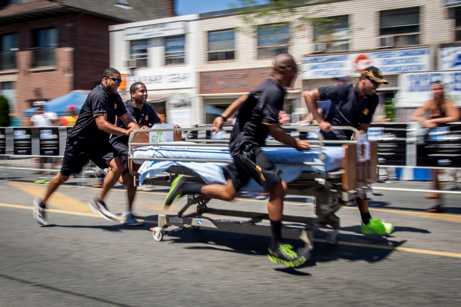 The Amalgamated Transit Union team races a bed down Danforth Avenue during the 7th annual Danforth Dash on Friday.  The event opened the Pilaros Taste of the Danforth festival and raised money for the Toronto East General Hospital Foundation. (August 9, 2013)