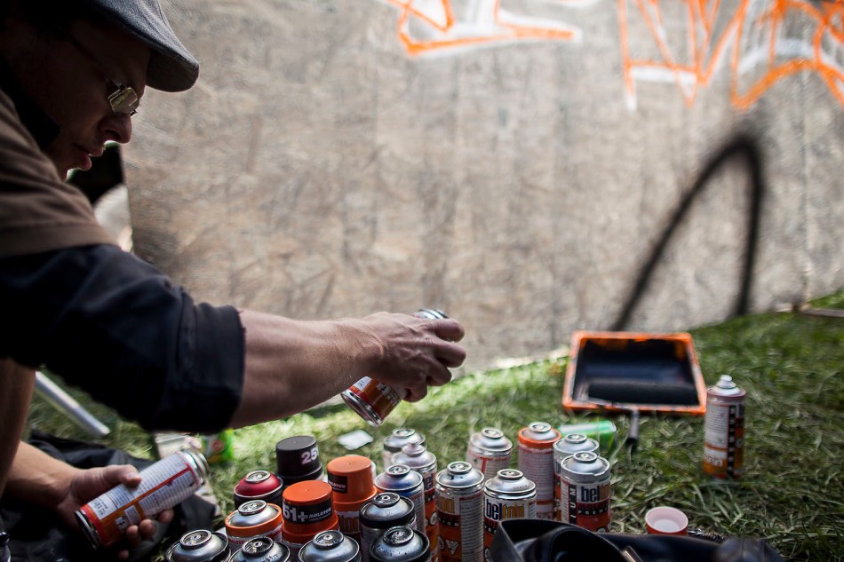 OTTAWA, ON (14/09/2013) - A graffiti writer, who requested he not be identified, selects a paint can while working on a piece during the tenth annual House of PainT urban arts and culture festival in Ottawa Ontario.  The festival brings together graffiti writers, break dancers and hip-hop music under an overpass for four days of music and art. (Photo by Adam Dietrich)