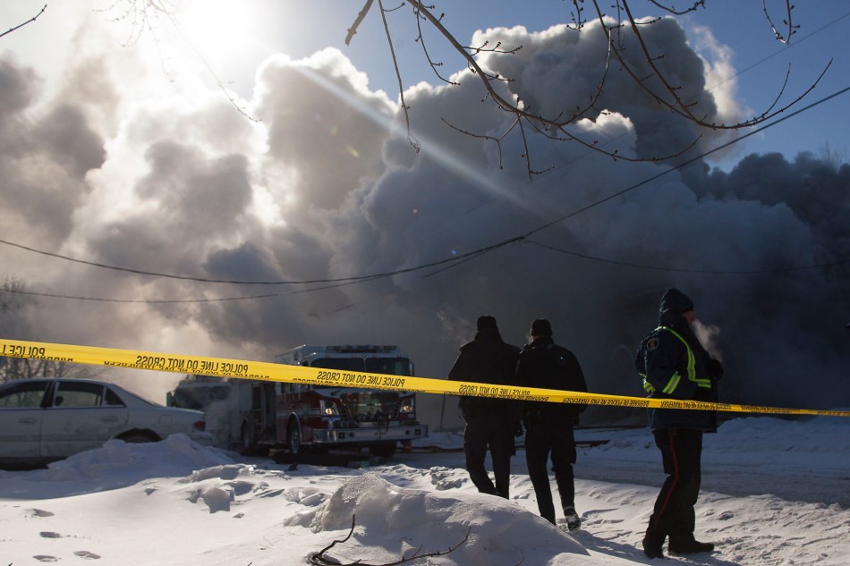 BELLEVILLE Ont. (3/1/14) - Fire crews work to douse a fire which sprung up in a two storey home on Grier Street in Belleville Ontario shortly before noon on January 3, 2014. (Photo Adam Dietrich)