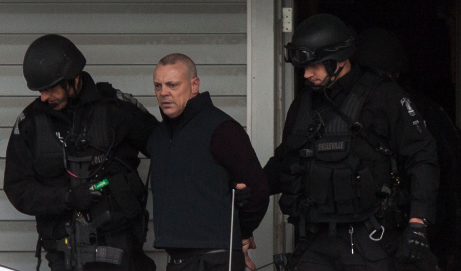 BELLEVILLE Ont. (21/11/2013) - A man is taken into custody after a three hour standoff with armed members of Belleville's emergency task force on November 21, 2013.  Police arrived at 56 Everett Street in the city's west end around 11am and apprehended a suspect around 2pm.  The man was later released without charge. (Photo by Adam Dietrich)