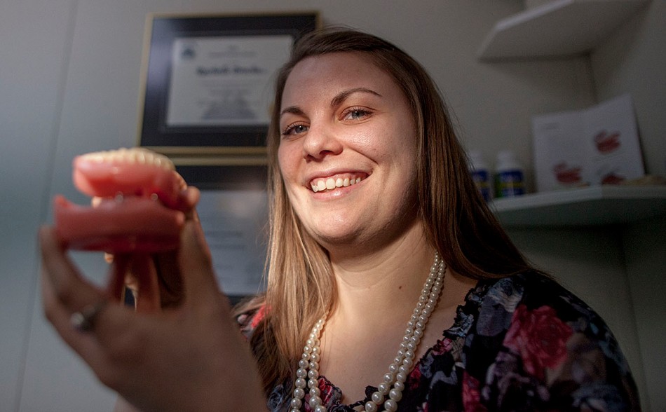 Denturist Rachelle Brochu is pictured holding up a sample of one of the dentures she builds in her Peace River Alberta office on Saturday April 12, 2014. ADAM DIETRICH/RECORD-GAZETTE/QMI AGENCY