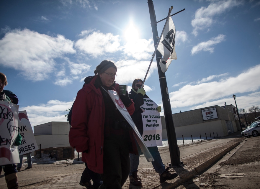 Members of the Alberta Union of Provincial Employees (AUPE), United Nurses of Alberta (UNA), Health Services and other supportive unions march in front of the constituency office of MLA Frank Oberle in Peace River Alberta on March 20, 2014.  The picket was part of a province-wide day of action held by several unions to protest proposed cuts to the pension plan for provincial employees and public sector workers. ADAM DIETRICH/RECORD-GAZETTE/QMI AGENCY