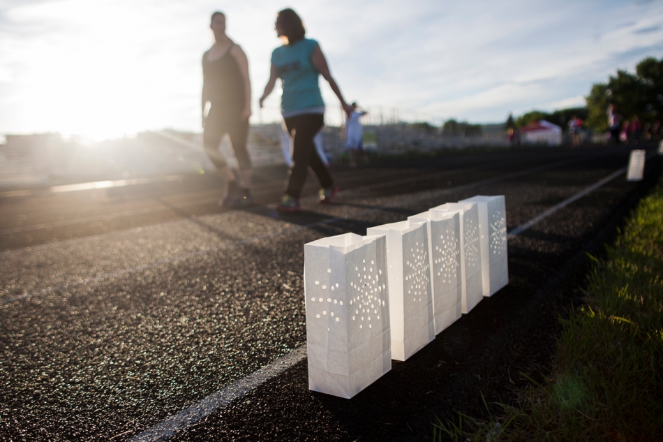 Luminaries, used as memorials by those who have been affected by cancer, are pictured next to the Glenmary High School track, while walkers from the Relay for Life walk it during the Relay for Life on Friday, June 20, 2014 in Peace River Alta. After taking 2013 off, the relay this in 2014 hoped to raise $25,000 for cancer research and they succeeded by raising $36,666. Adam Dietrich | Record-Gazette/QMI Agency