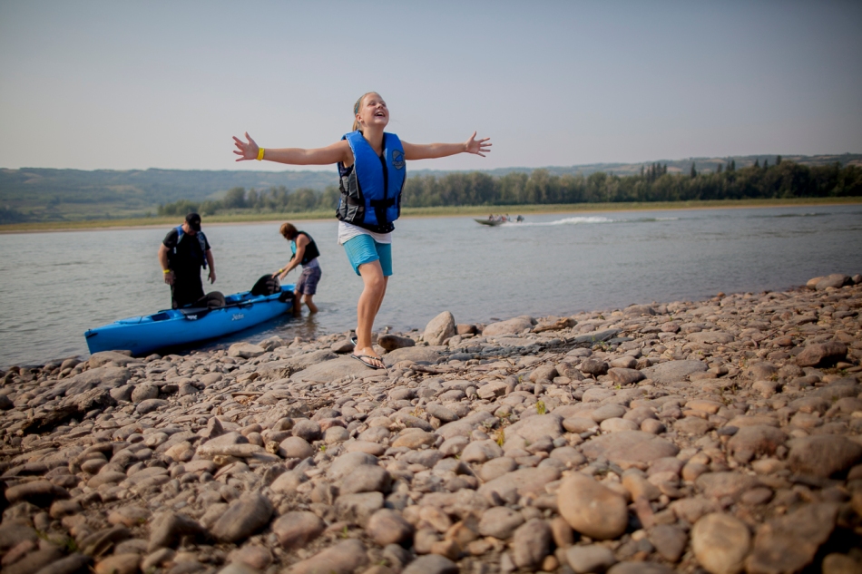 Jessica Raymond, from Peace River, celebrates completing the Paddle the Peace event in Peace River, Alta. on Sunday, Aug. 17, 2014. Adam Dietrich | Record-Gazette/QMI Agency