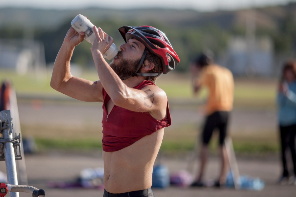 Jesse Labatiuk drinks some water before starting the bicycle portion of the TriRiver Triathlon on Peace River, Alta. on Sunday Aug. 24, 2014. Adam Dietrich | Record-Gazette/QMI Agency
