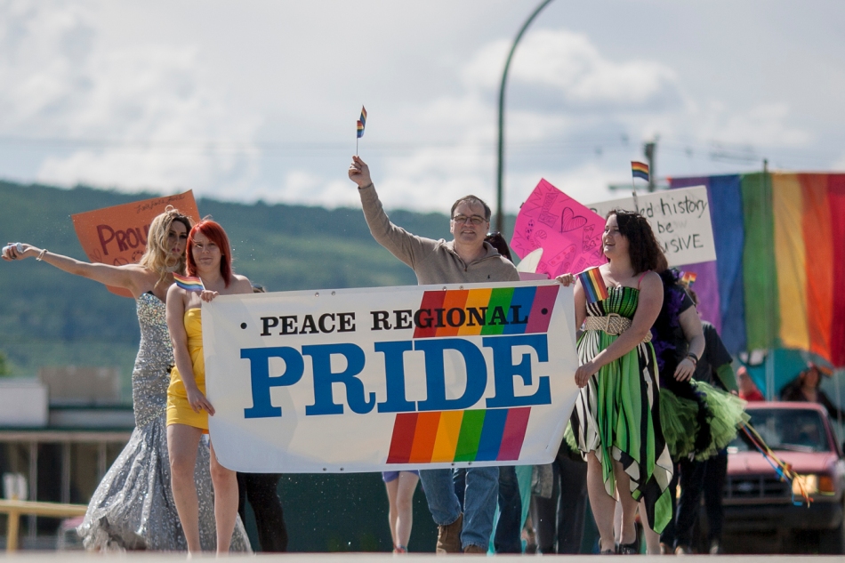 From left to right, drag queen Victoria SecRet, Amber Pratt, Mayor Tom Tarpey and Ashley Pratt lead the Peace Regional Pride Parade through downtown Peace River Alberta on Saturday June 7, 2014. Adam Dietrich | Record-Gazette/QMI Agency