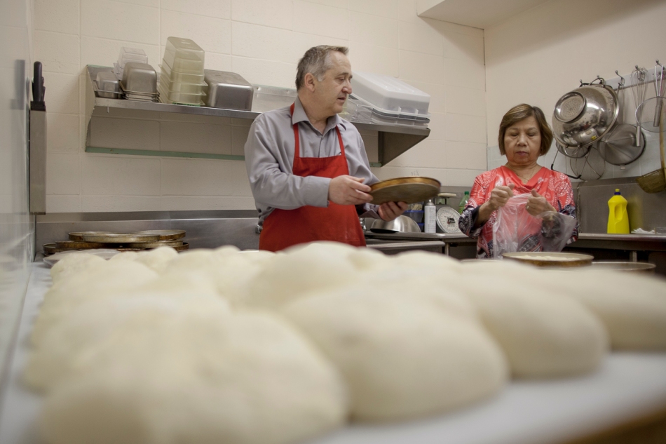  From left, Ali Dalman and Ming Gaunt work to prepare pizza dough in the back of Matt's Pizza prior to opening on Saturday, June 14, 2014 in north-end Peace River, Alberta. Adam Dietrich | Record-Gazette/QMI Agency